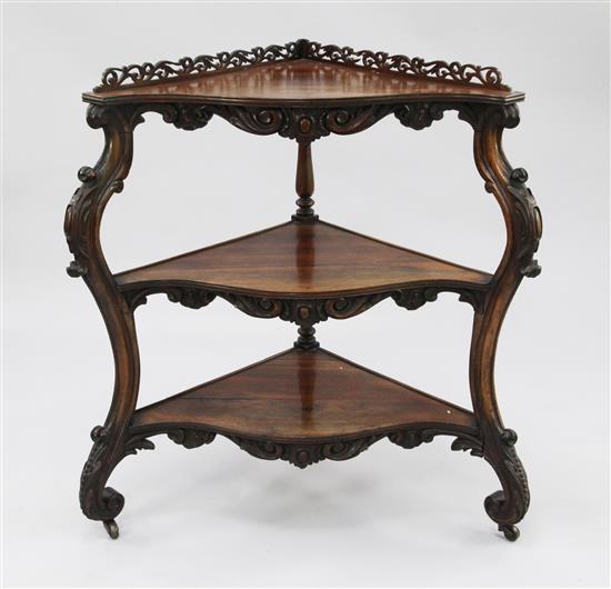 A Victorian rosewood three tier corner whatnot, W.2ft 8in.